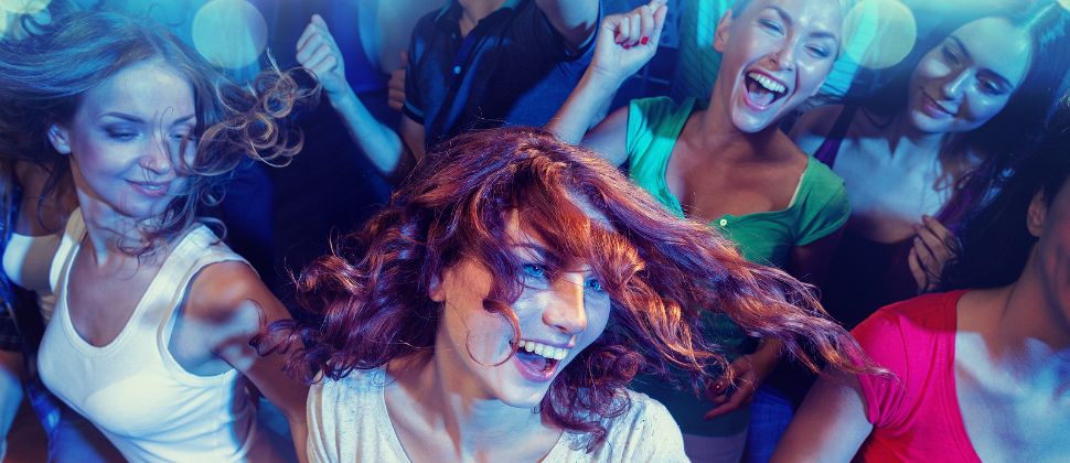 A Bachelorette Party Dancing Together In A Nightclub.
